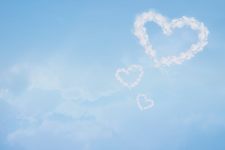 Heart shaped cloud in blue sky. Valentine and wedding background.の写真素材