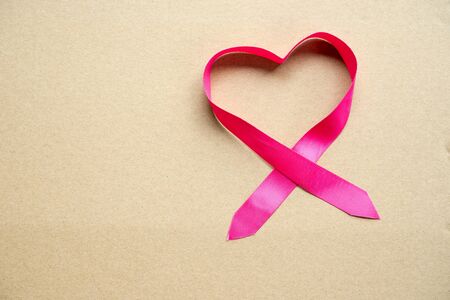 Red heart made of ribbon on paper for valentine and wedding  background.の写真素材