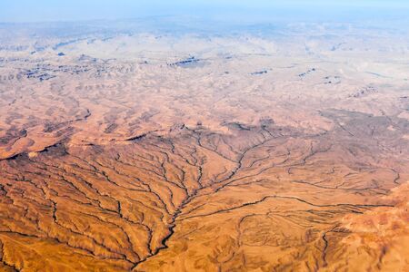 Mountain view from above. The tops of the mountains at sunset from airplane.の写真素材