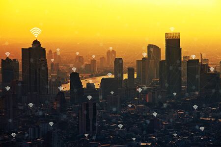 Modern connection in business district city at sunset. Wifi connection technology concept.の写真素材