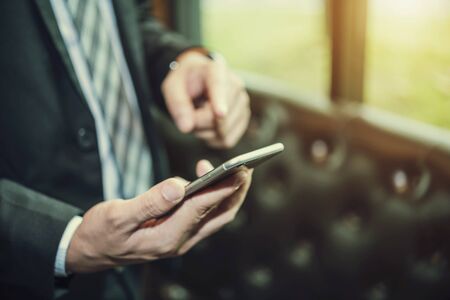 Business connection technology concept. Hand of business man using smartphone to contact to people. Future global communication.の写真素材