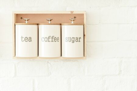 Tea, coffee, sugar pot decoration hanging on white wall. Food and kitchen background.の写真素材