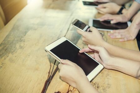 Modern business with new technology on smartphone concept. People using mobile in cafe for working and online connect to the world. E-commerce.の写真素材