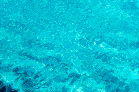 A close up shot of water in swimming pool  as the sunlight reflection. Abstract background.の写真素材
