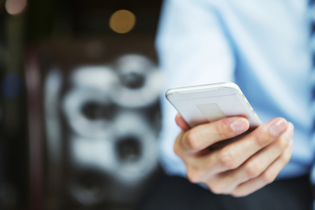 Business technology, businessman working wireless online with smartphone with blurred background.の写真素材