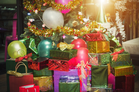 Christmas gift giving concept. Many present boxs with ribbons in party room. Celebrate party background.の写真素材