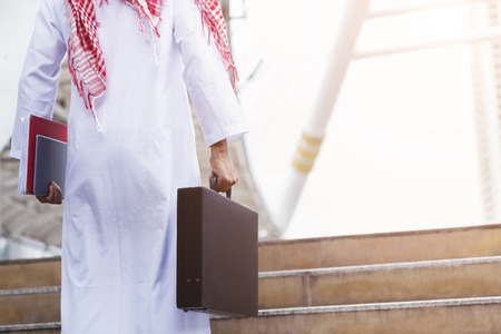 Arab businessman holding file and business bag with free copy space. Picture for add text message. Backdrop for design art work.の写真素材