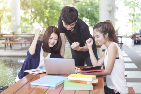 Group of young students happiness when finished homework and report in school.の写真素材