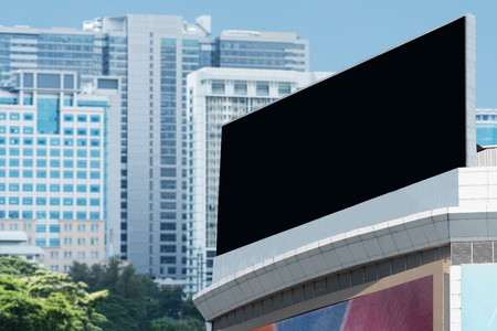 Blank billboard. Blank poster for outdoor advertising. Blank billboard with blue sky and modern building. Big blank billboard for advertisement.の写真素材