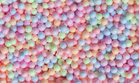 Abstract background from colorful small foam balls patter in box. Happy holiday and travel...