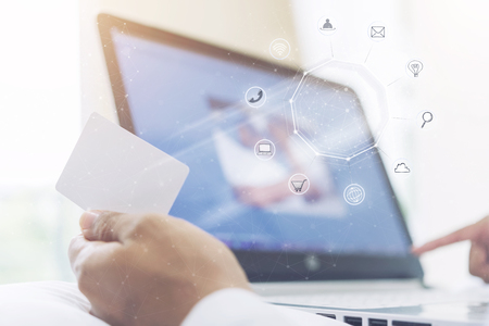 Online business technology concept. E-commerce, worldwide connection, global communication. Business people making payment, shopping, internet online transaction with credit card and computer laptop.の写真素材