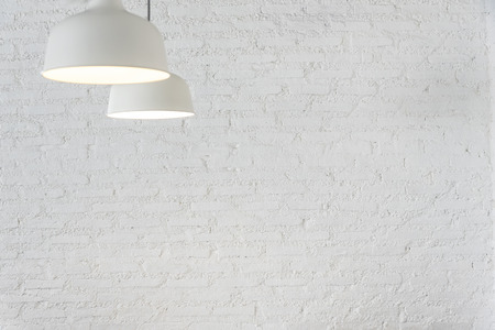 White lamps with blurred white brick wall background. Electronic and lighting background concept. Vintage backdrop. Picture for add text message. Backdrop for design art work.の写真素材