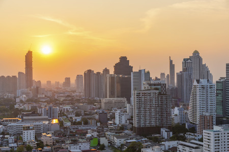 High modern building in business city center of Bangkok at sunset. Travel to Thailand.の写真素材