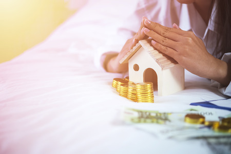 Mortgage concept, house and money with free space for text. Saving loan banking.の写真素材