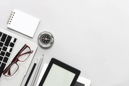 Business and technology concept. Closeup of business devices with compass on white table, success business concept.の写真素材