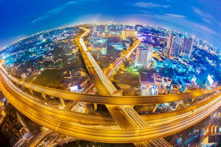 Light trail on expressway in Bangkok city. Skyscrapers of traffic and transportation in modern city.の写真素材