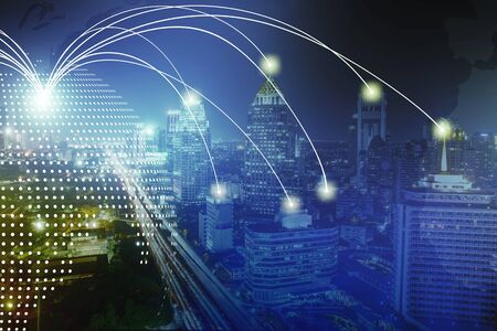 Modern wireless connection technology in smart city. Closeup dots globe with connection lines and dots over high building in business center city at night.の写真素材