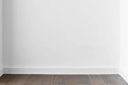 Abstract background from blank white concrete wall at home or office with wooden floor. Picture for add text message. Backdrop for design art work.の写真素材
