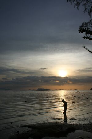 Little boy walking the beach sunset on Koh Samui. Surat Thani Province, Thailandの写真素材