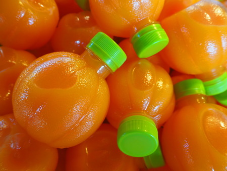 Orange juice in plastic bottlesの写真素材