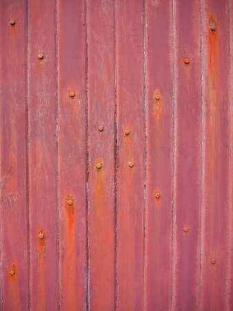 Old brown wood wall with rust