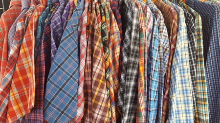 many Striped colorful trousers on hanger for background