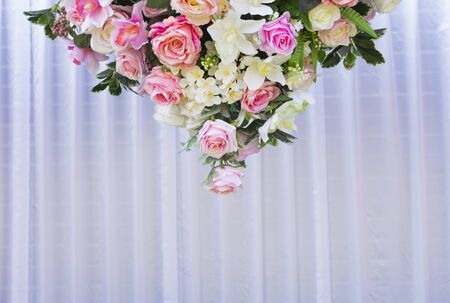 White, pink, and red roses arranged beautifully in a triangle for the background.の写真素材