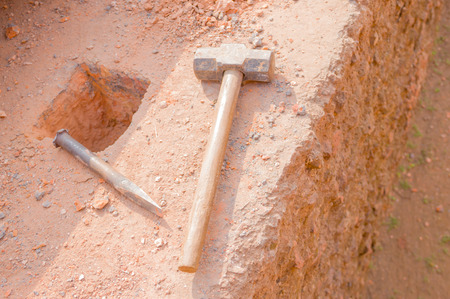 heavy old hammer left on the ground image .の写真素材