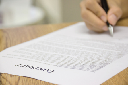 Business worker signing the contract to conclude a deal. selected focus.の写真素材