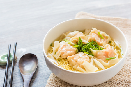 Shrimp wonton with braised pork in soup on wooden table - Asian food style, Select focus imageの素材 [FY31098468819]