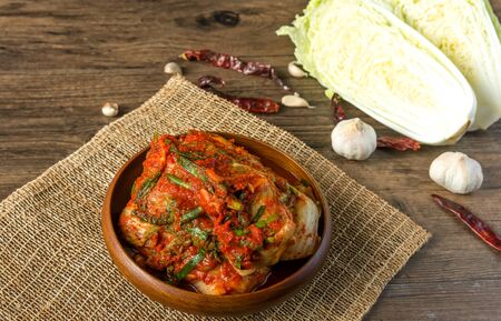 Traditional Korean Kimchi in a bowl on wooden background, top view, Korean food ,Korean food traditional cuisine. Fermented food. Vegetarian food good for health, Vegan for weight control dietの写真素材