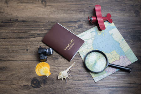 time to travel in vocation concept, wanderlust holiday background flat lay, space for text. camera passport map camera on wooden table. planning summer holiday. Travel and tourism concept.の写真素材
