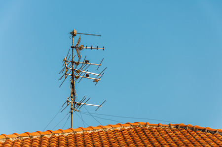 TV antenna on red roofの写真素材