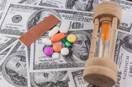 sandglass & medicine on banknotes