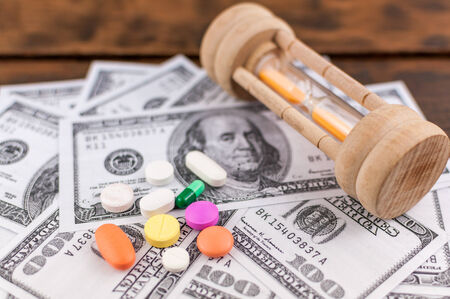 sandglass   medicine on banknotesの写真素材