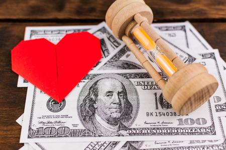 Heart, sandglass   banknotes  concept for love, money   time
