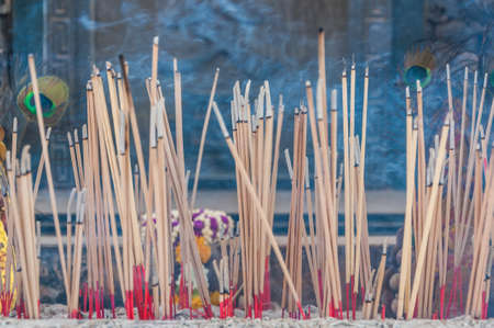 Incense sticks in ashes bucketの写真素材