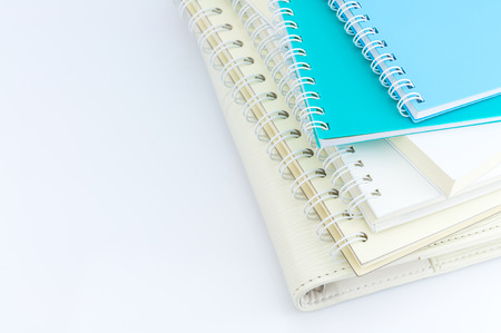 stack of organizer and notebooks on white background