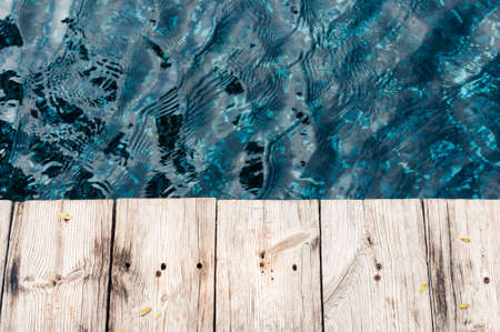 Wood planks against blue water backgroundの写真素材