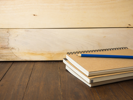 Pencil over stack of books on wooden table, education concept.の写真素材