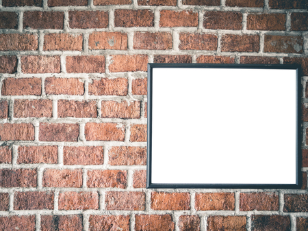 Blank photo frame on red brick wall with vintage filter.の写真素材