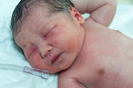 Newborn in hospital, just arrive in nursery room.の写真素材