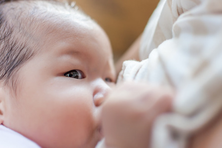 Breastfeeding at home.の写真素材