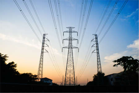 three  power towers with power lines with blue sky