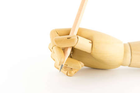 wooden hand isolated on white: holding a pencilの写真素材