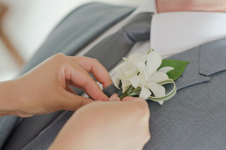 hand with a flower on the suitの写真素材