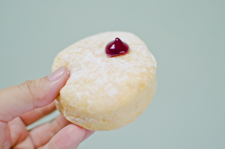 hand with donuts blueberry jam, photo shoot by depth of field for objectの写真素材