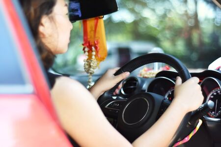 Blurred portrait of young asian lady sitting in sport carの写真素材