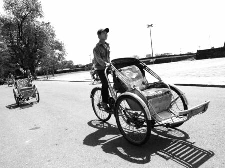 DA NANG, VIETNAM : Unidentified man ride tricycle in front of the palace for tourist on April 8, 2008 in Da Nang, Vietnam.   のeditorial素材