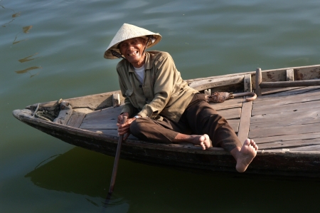DA NANG, VIETNAM :  Unidentified old Vietnamese smiling in his boat for tourist on April 8, 2008のeditorial素材
